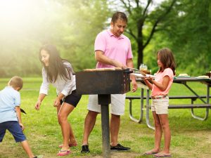 Small family cooks out in park