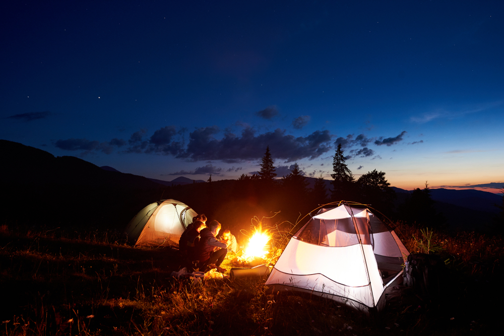 Hikers in tents on mountain at night