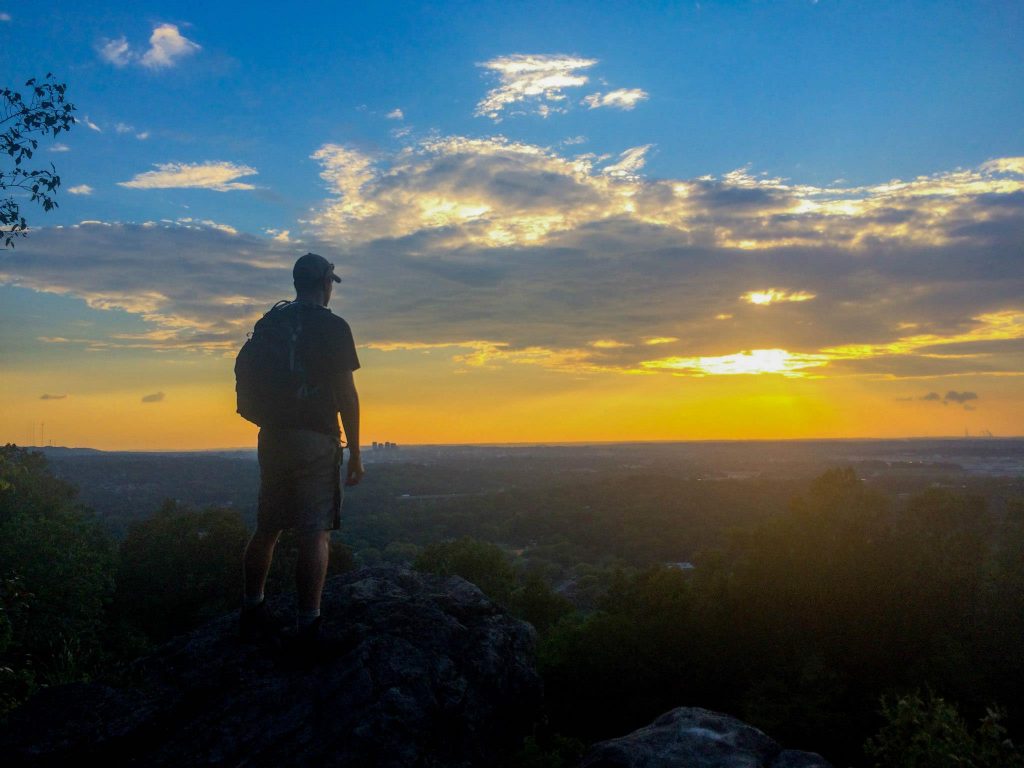 Hiker marvels at sunset view.